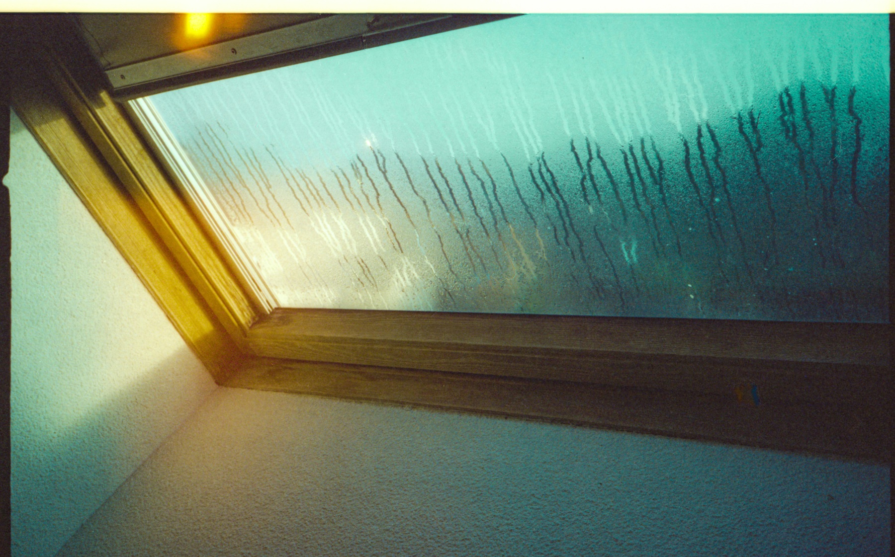 Condensation on a window pane, a common sign of high indoor humidity in a house