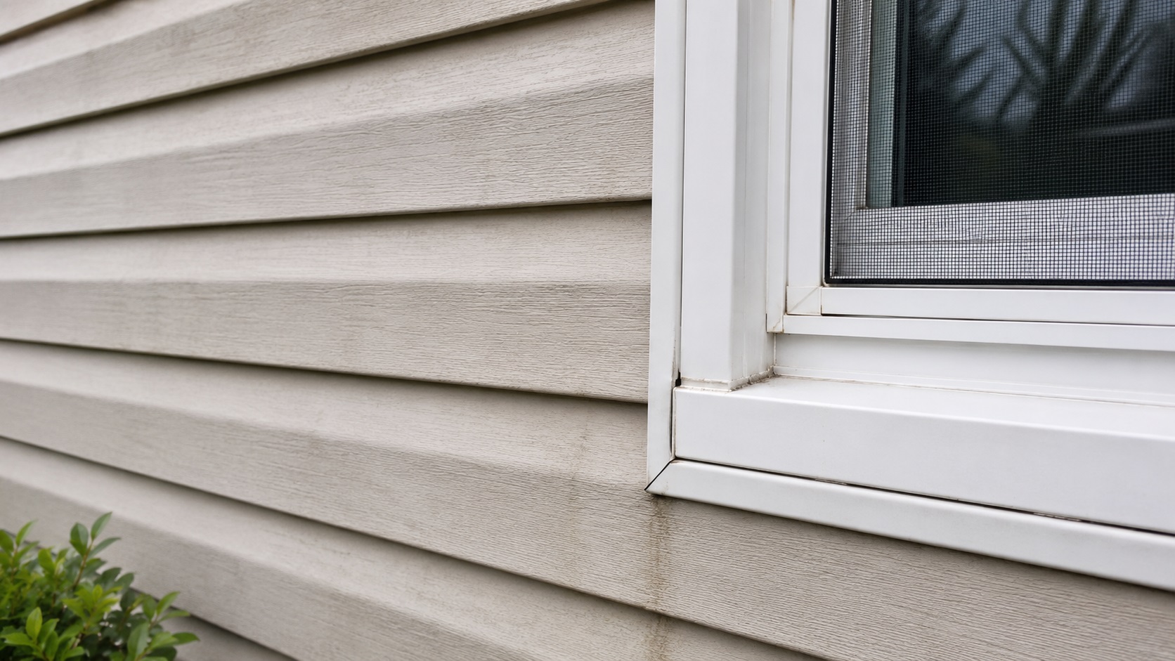 Exterior wall with damaged siding and trim gaps that may allow moisture into the home